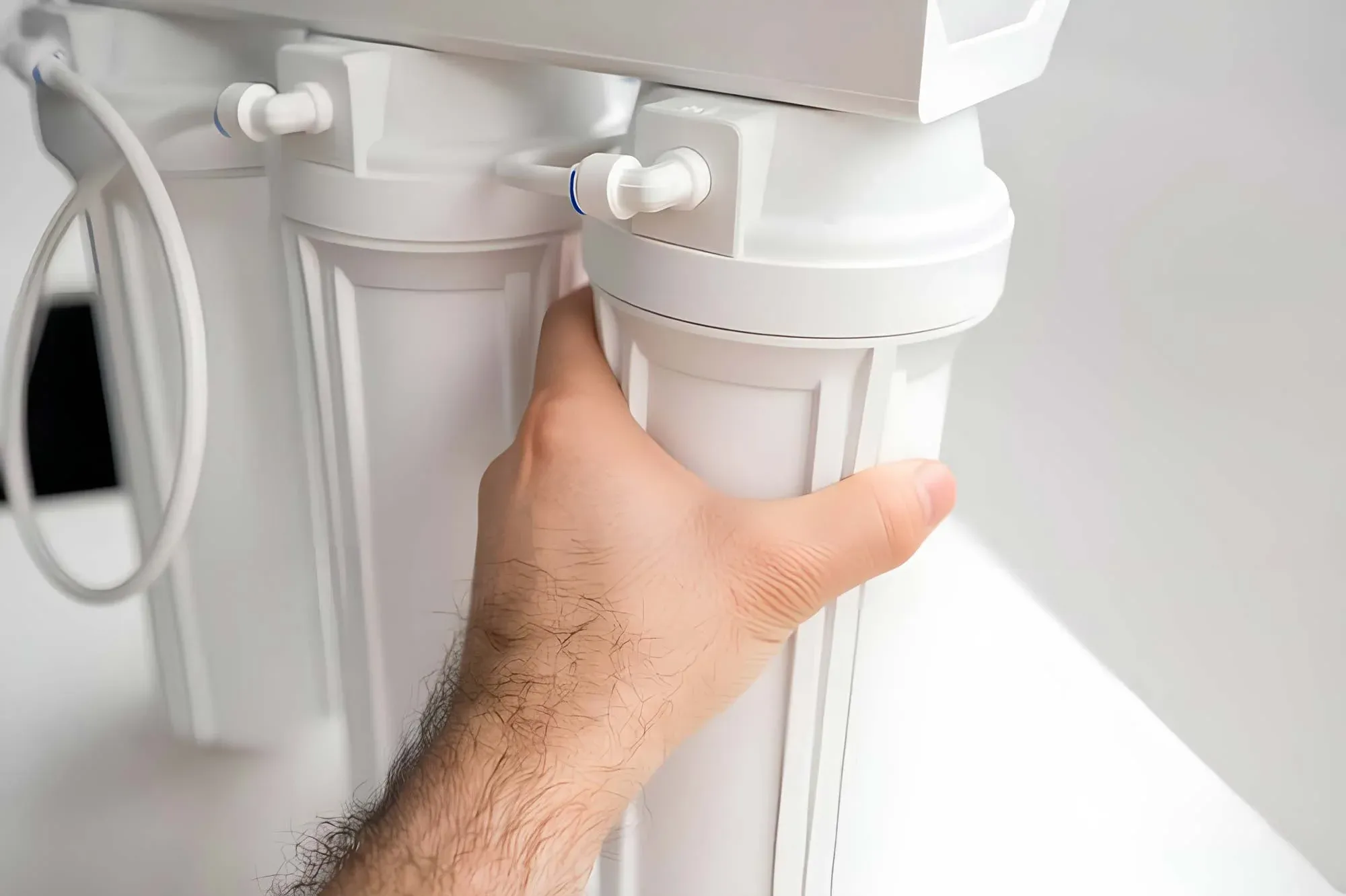 A reverse-osmosis water filtration system installed under a sink